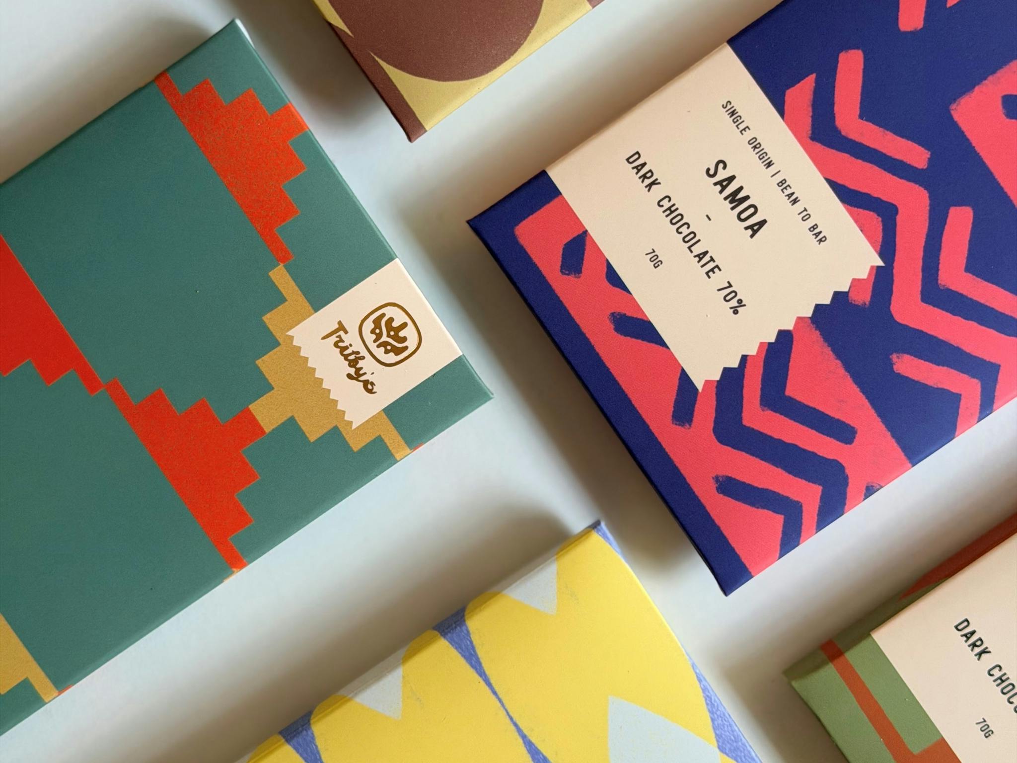 Flat lay of Trilby’s colourful chocolate bars arranged on a light background.