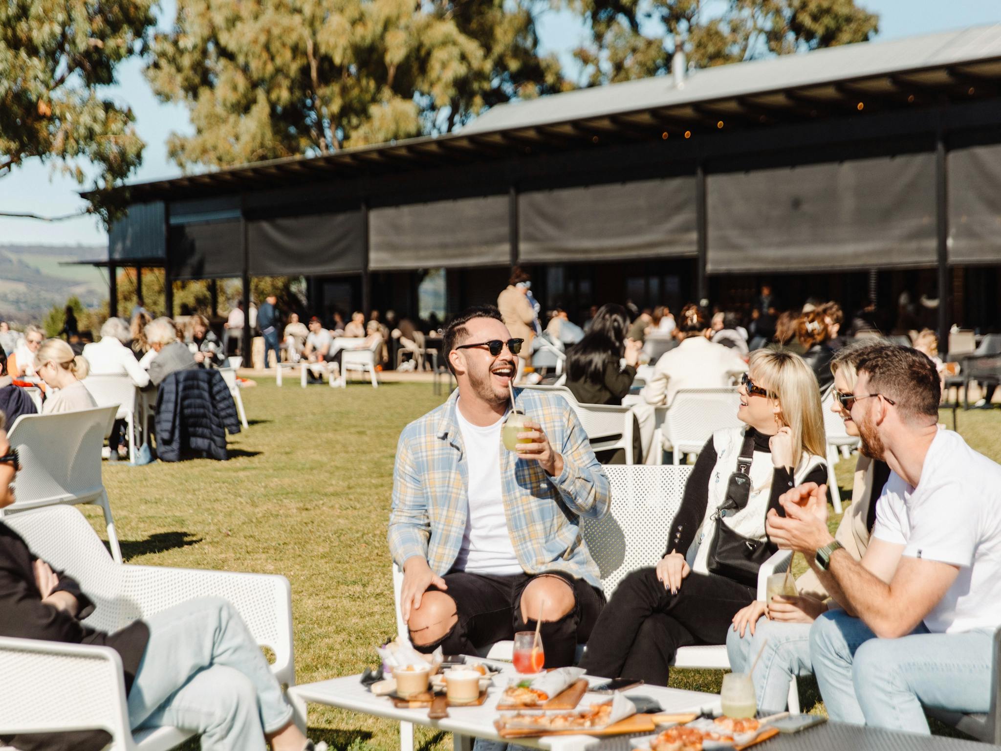 guests enjoying drinks and pizza on the lawns