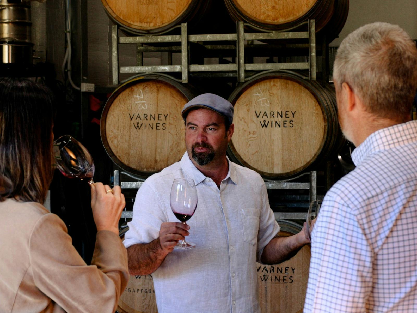 Alan Varney with guests in the barrel room at Varney Wines