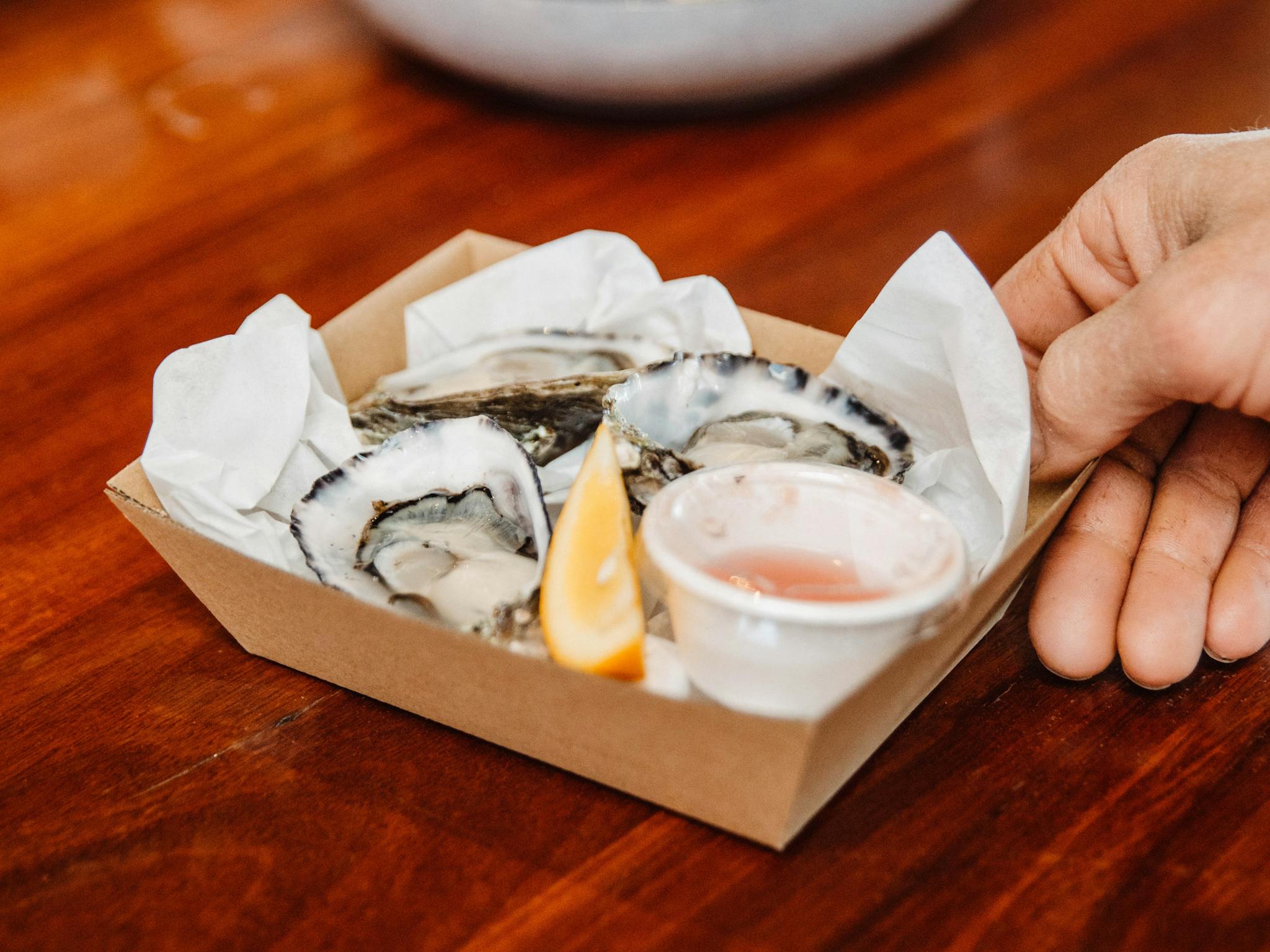 a dozen oysters with cold dressings and fresh lemon