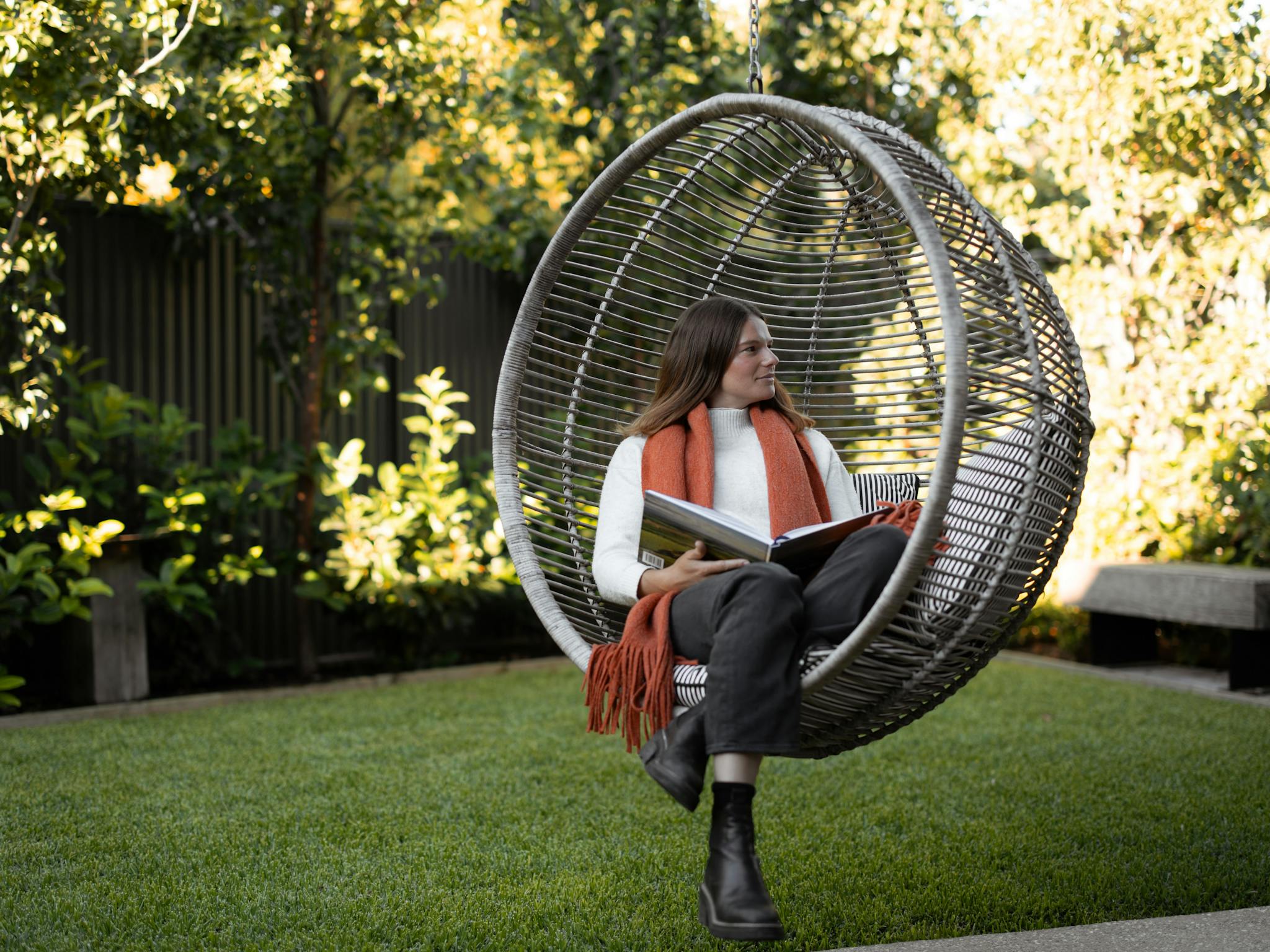 Woman sitting in hanging chair in a garden at Vale 194 McLaren Vale