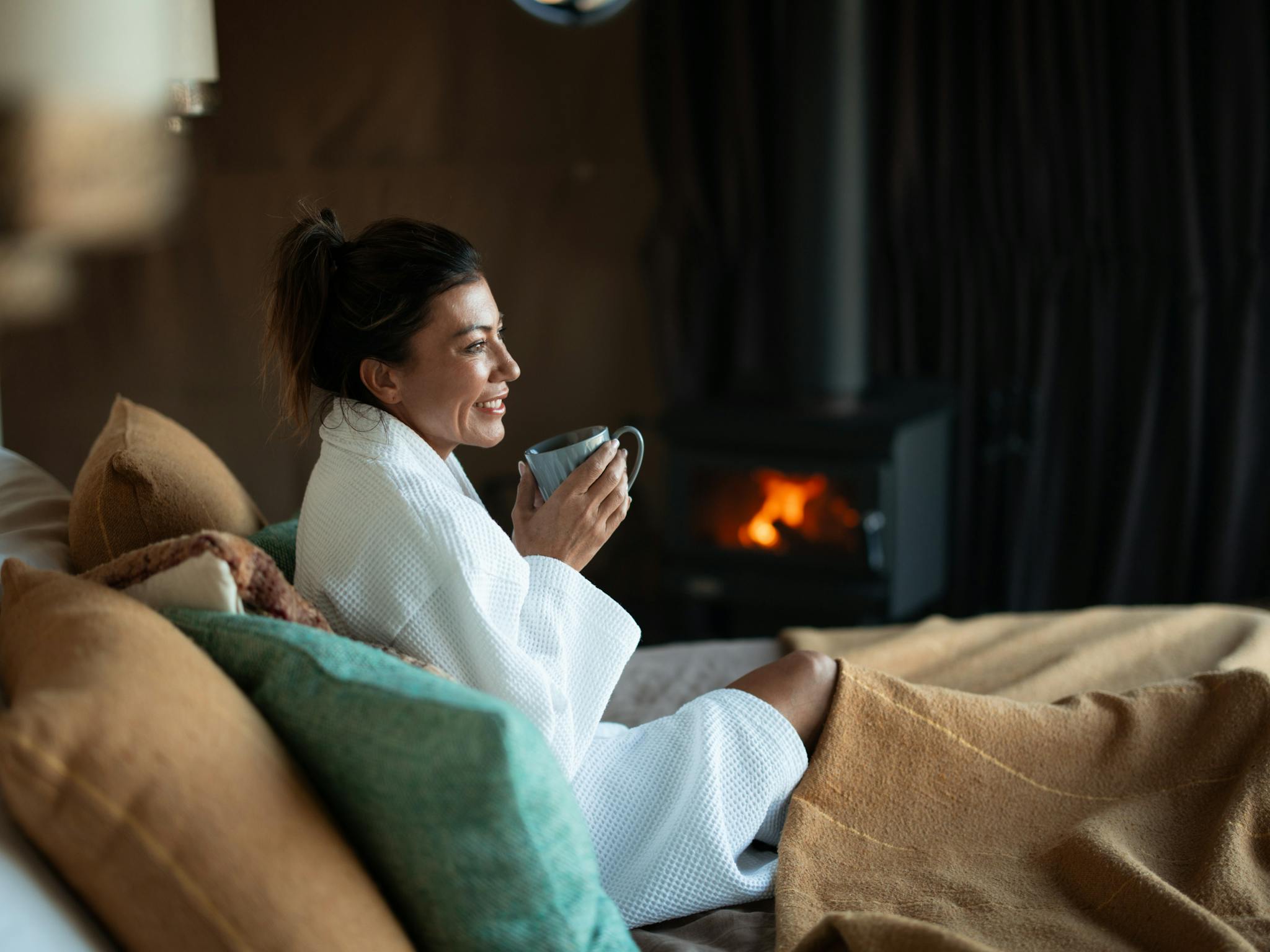 Guest sipping coffee by the fire
