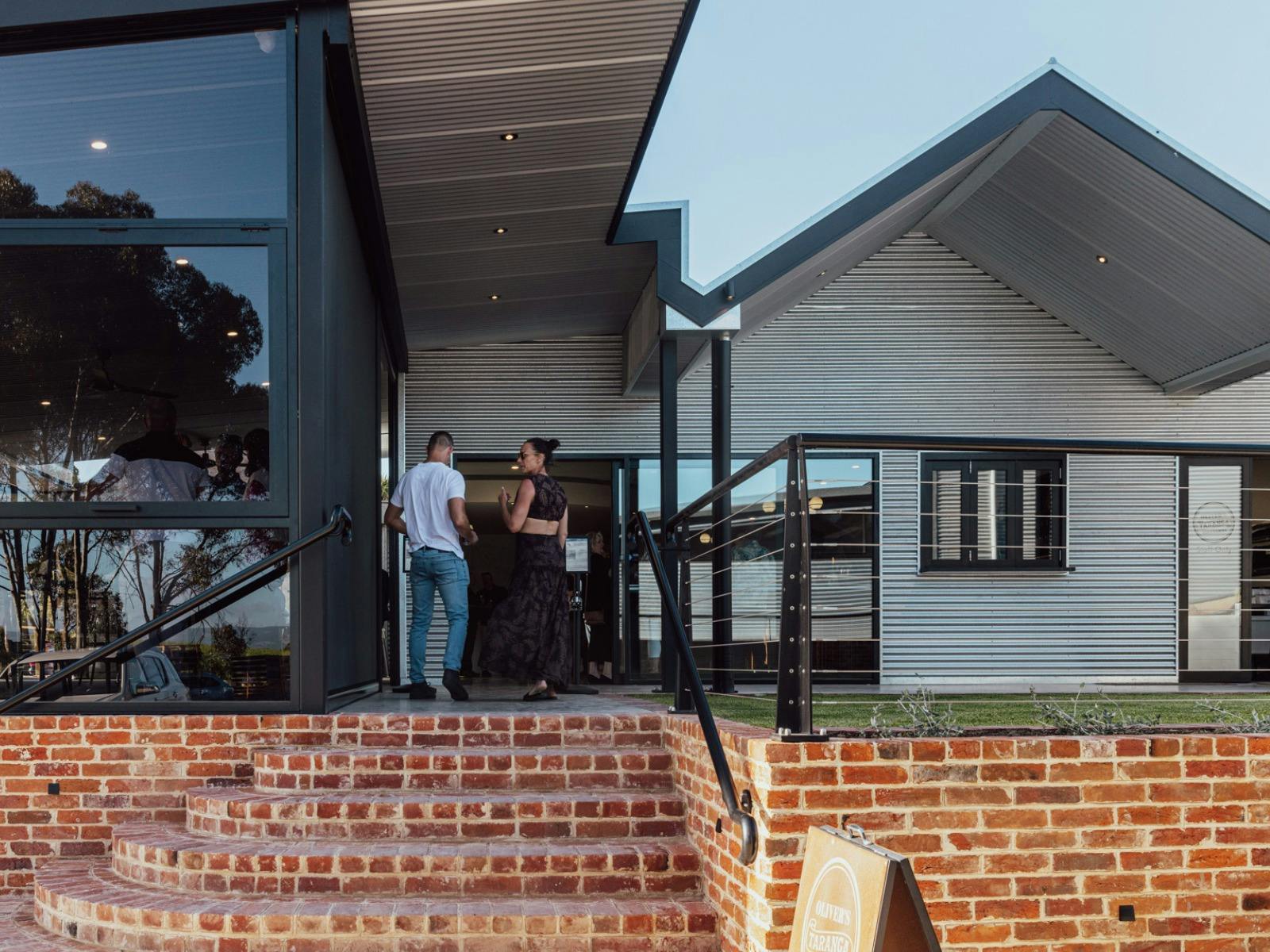 Couple walking up stairs to Oliver's Taranga entrance