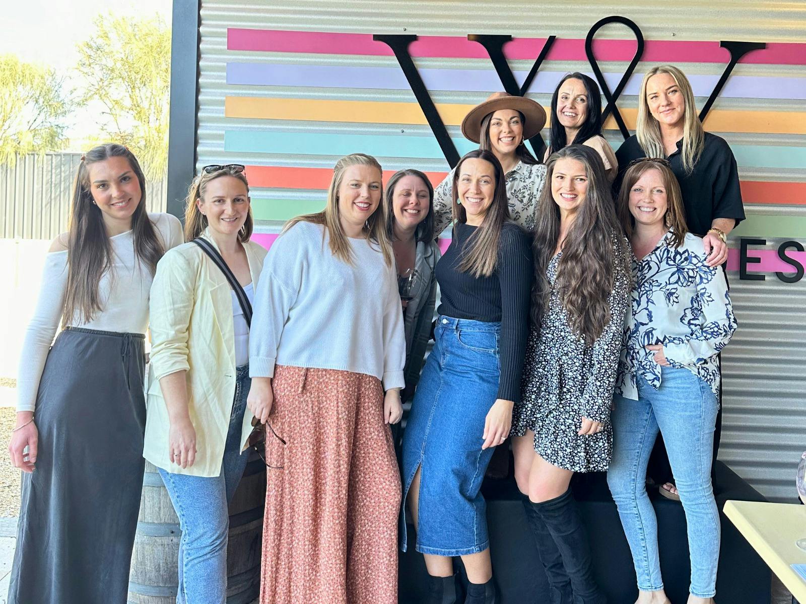 Young women smiling and having a photo taken at the Varney Wines Tasting Room in McLaren Vale.