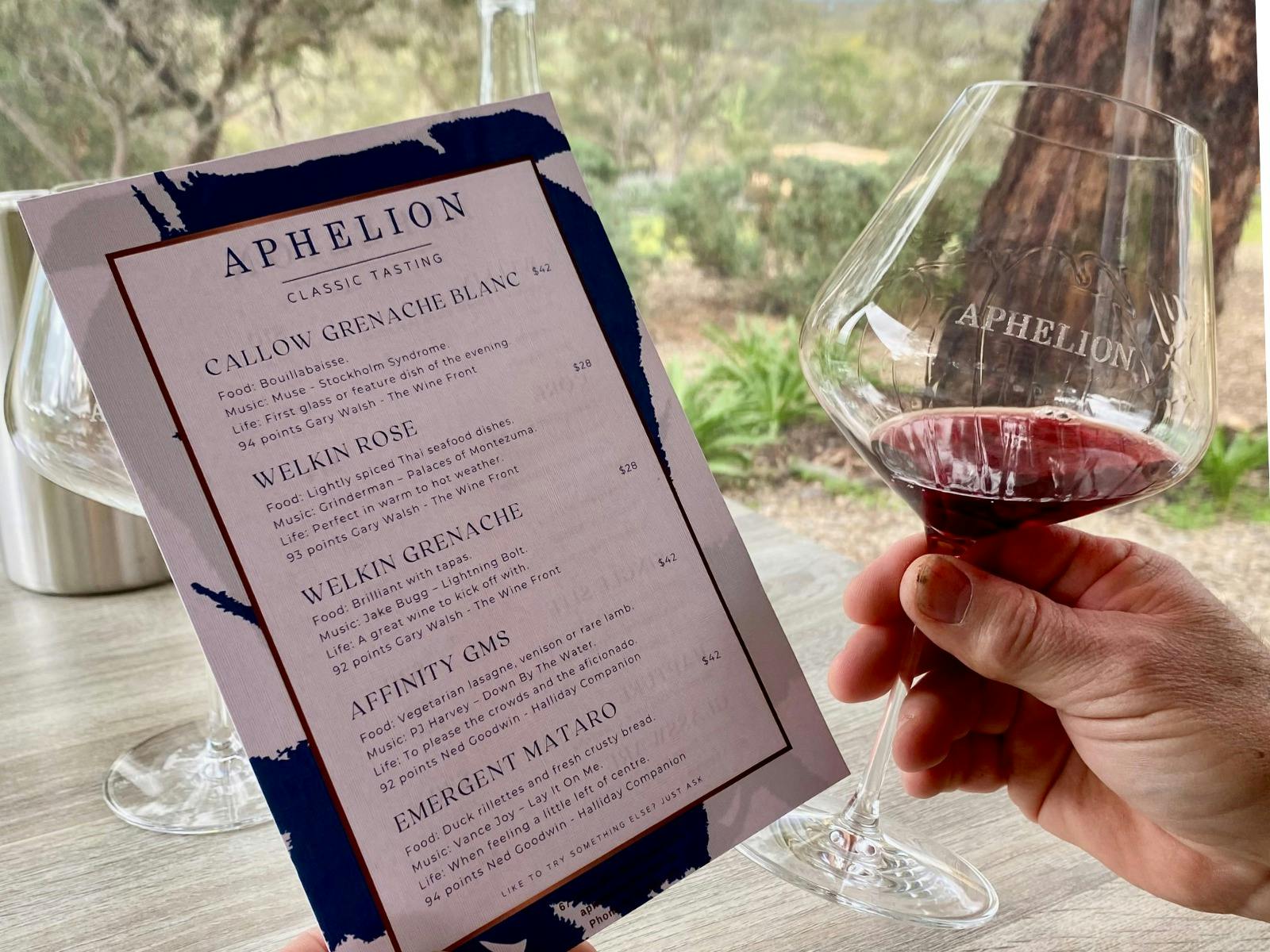 A glass of red wine and the Classic Tasting Card at Aphelion Cellar Door