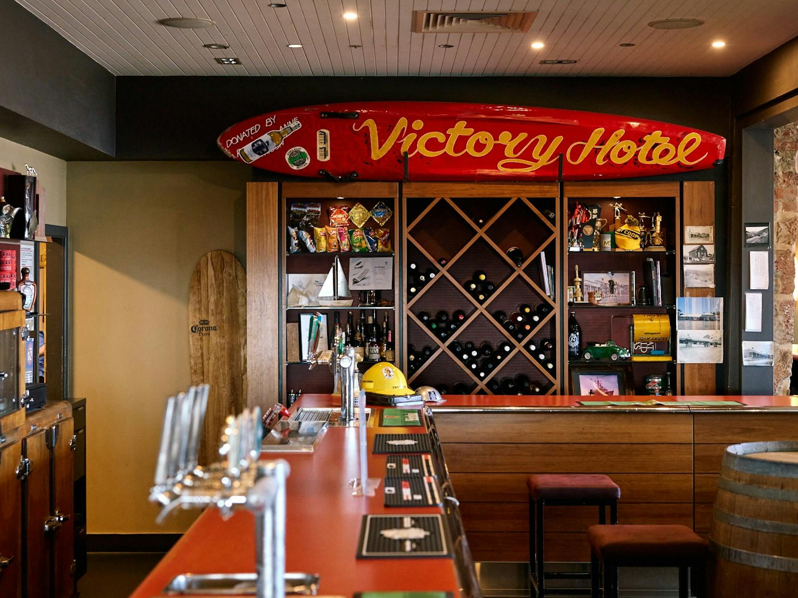 Front bar with surfboard and beer taps in background