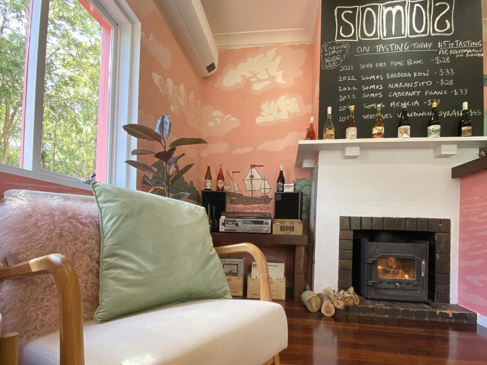 The interior of Somos Wines Cellear door with fireplace and warm colours