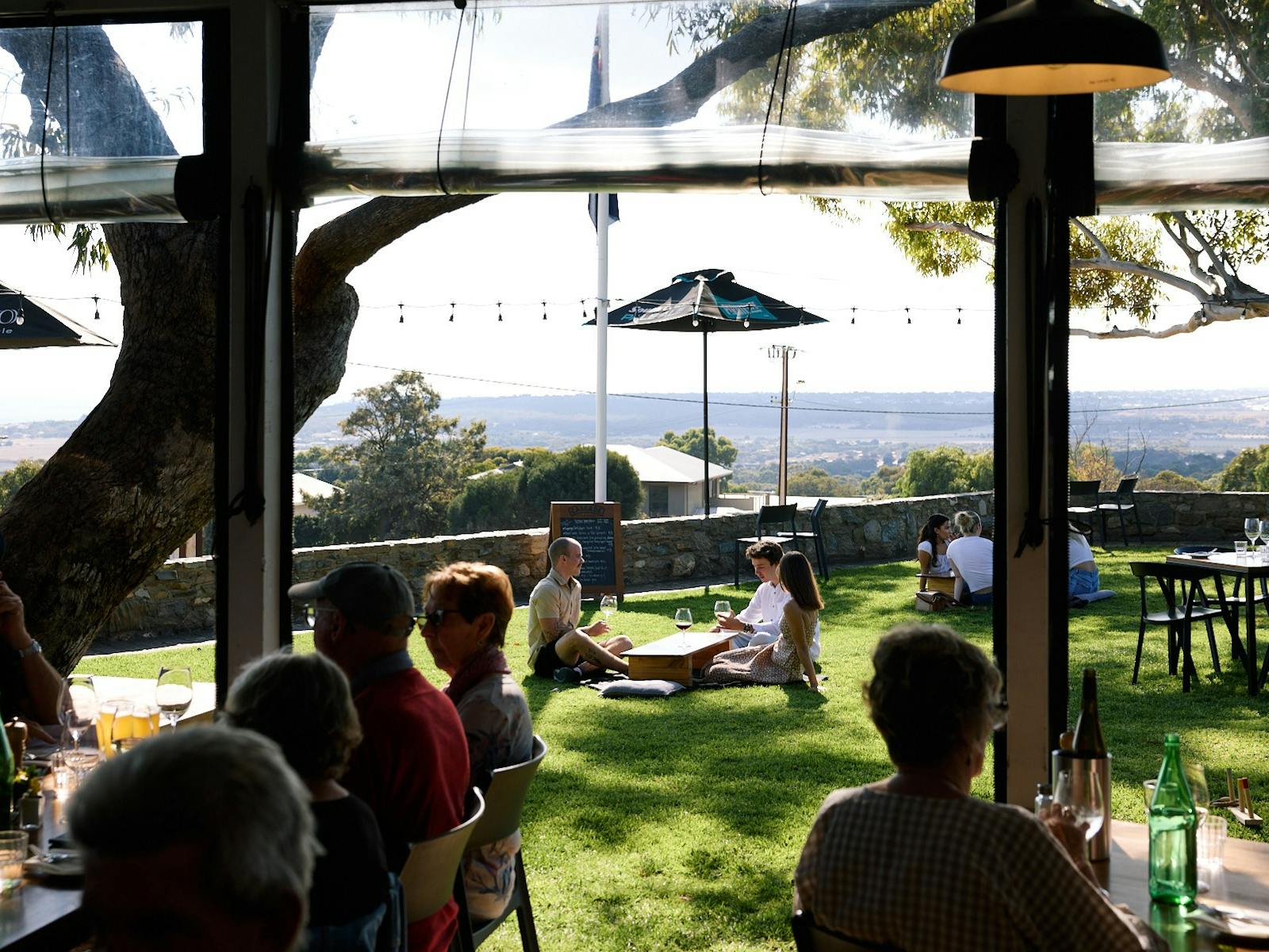 outdoor dining area with views of coastline in the distance