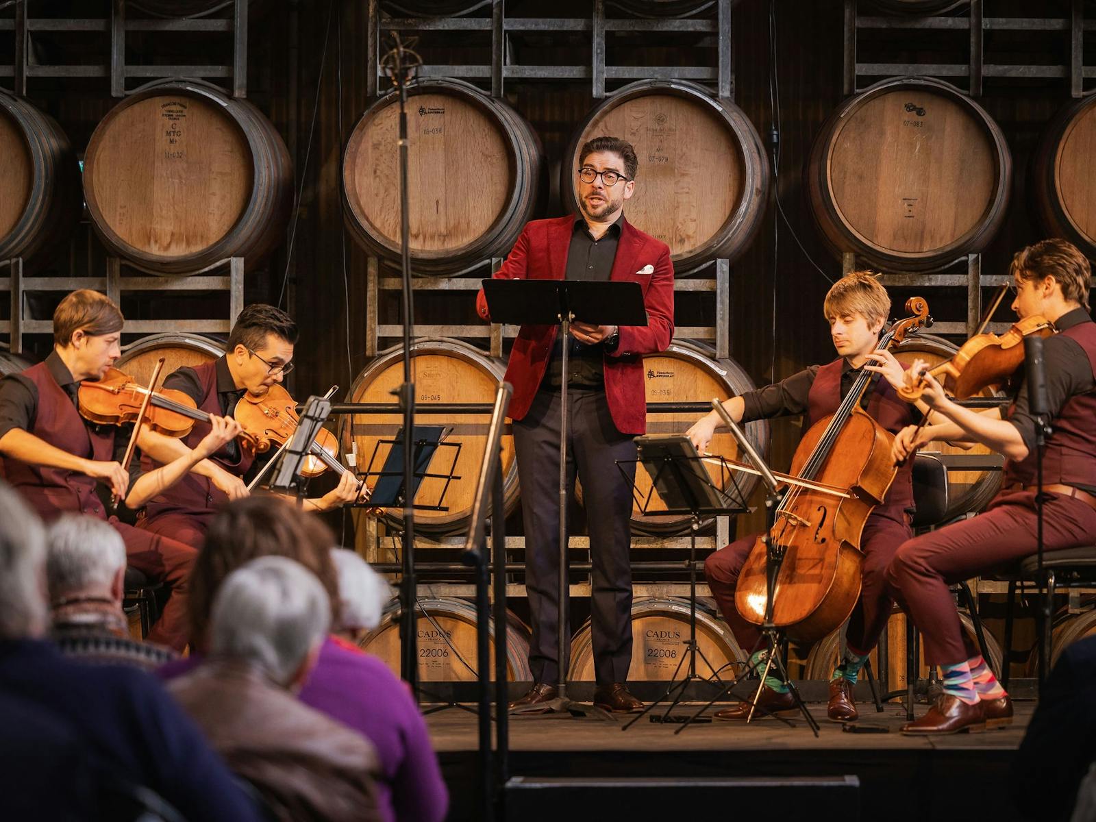 musicians performing with a singer in their middle
