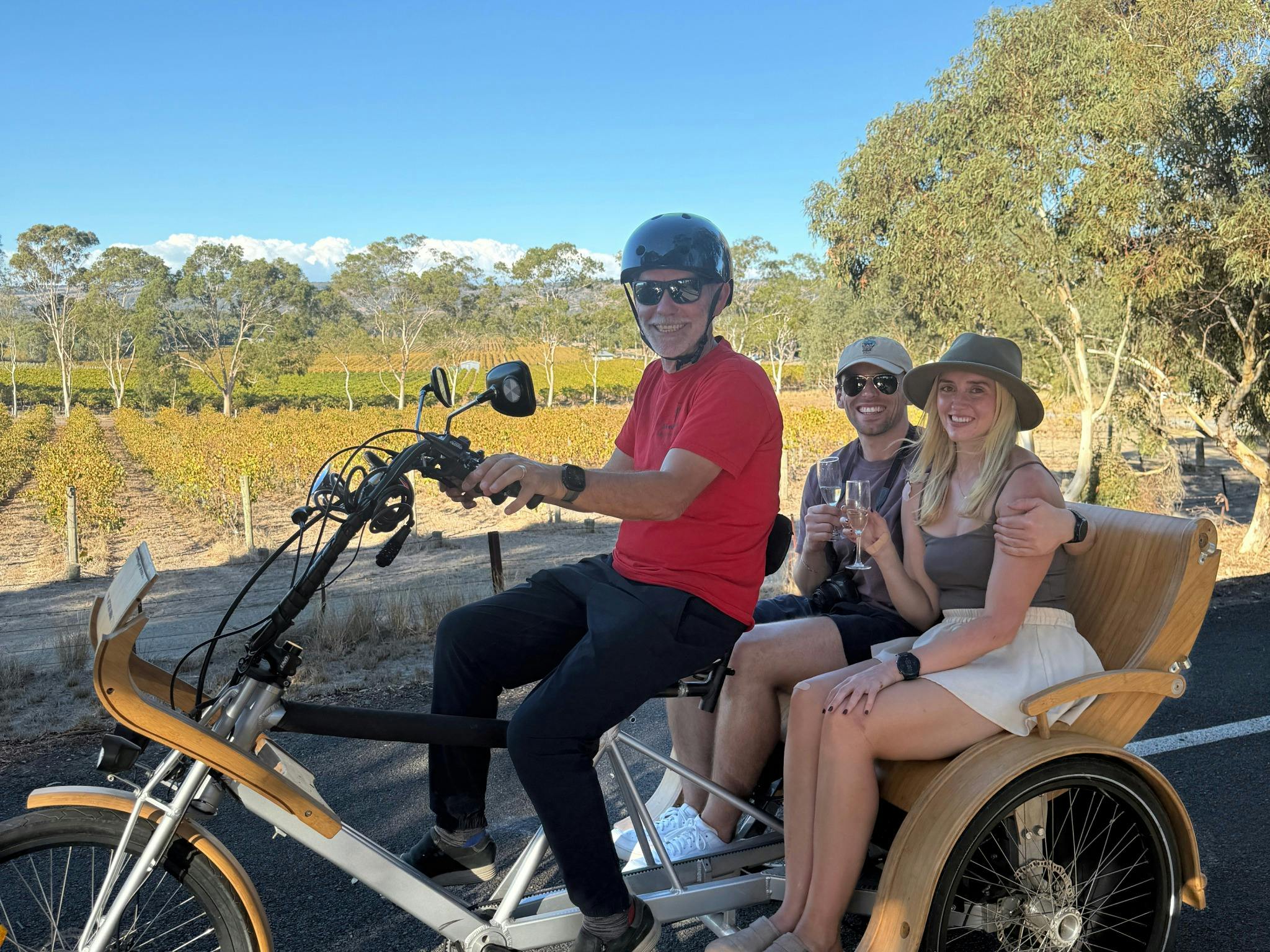 eTukTuk on the Shiraz Trail, McLaren Vale, passengers drinking sparkling wine