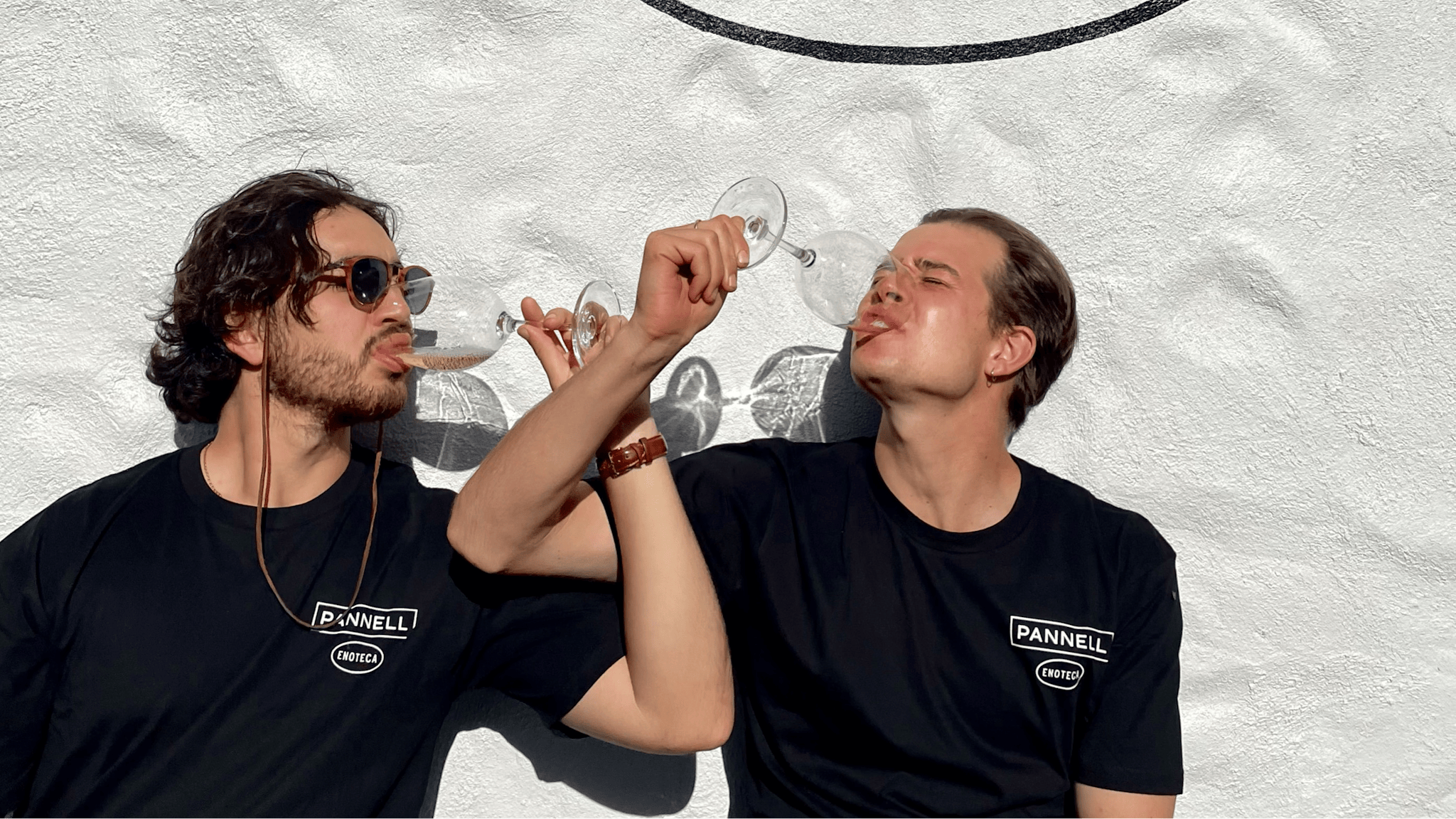 people drinking wine infront of Pannell Enoteca sign